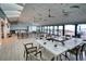 Bright community room with ocean views, tables, and chairs at 1935 Gulf Of Mexico Dr # G7-302, Longboat Key, FL 34228