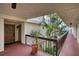 Condo hallway with brick floor and tropical plants at 1935 Gulf Of Mexico Dr # G7-302, Longboat Key, FL 34228