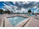 Relaxing hot tub surrounded by lounge chairs and umbrellas at 1935 Gulf Of Mexico Dr # G7-302, Longboat Key, FL 34228
