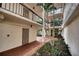 Tranquil courtyard featuring brick paths and palm trees at 1935 Gulf Of Mexico Dr # G7-302, Longboat Key, FL 34228