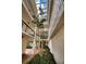 Lush courtyard with brick pathway and tropical plants at 1935 Gulf Of Mexico Dr # G7-302, Longboat Key, FL 34228