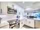 Modern kitchen with white cabinets and stainless steel appliances at 1935 Gulf Of Mexico Dr # G7-302, Longboat Key, FL 34228