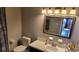 Bathroom with vanity sink, toilet, mirror, and shower with a decorative curtain at 214 Genet Ct, Sun City Center, FL 33573