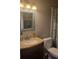 Well-lit bathroom featuring a vanity, toilet, and shower/tub combo at 214 Genet Ct, Sun City Center, FL 33573