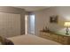 Bedroom featuring a king-size bed, dresser, closet doors, and artwork at 214 Genet Ct, Sun City Center, FL 33573