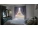 Cozy bedroom with large window, dresser, and comfortable bed at 214 Genet Ct, Sun City Center, FL 33573