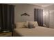 Bedroom with a king-size bed, nightstand, floor lamp, and decorative wall accent at 214 Genet Ct, Sun City Center, FL 33573