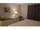 Bedroom with a king-size bed, dresser, chair, and artwork on the wall at 214 Genet Ct, Sun City Center, FL 33573