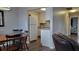 Dining area with wooden table and chairs, and view of the adjacent kitchen at 214 Genet Ct, Sun City Center, FL 33573
