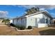 Side view of a single-story home with light blue siding and white trim at 214 Genet Ct, Sun City Center, FL 33573