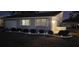 Charming home's exterior at night with landscape lighting at 214 Genet Ct, Sun City Center, FL 33573