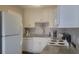 Bright, updated kitchen with white shaker cabinets, speckled granite counters, and stainless appliances at 214 Genet Ct, Sun City Center, FL 33573