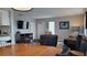 Living room and dining area with wood floors, leather furniture, and a door leading outside at 214 Genet Ct, Sun City Center, FL 33573