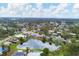 Wide aerial view of neighborhood with lake and lush trees at 2215 39Th W St, Bradenton, FL 34205
