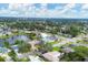 An aerial view of a neighborhood featuring houses and a central lake at 2215 39Th W St, Bradenton, FL 34205