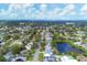 Aerial view of a residential area with houses, roads, and a pond at 2215 39Th W St, Bradenton, FL 34205