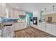 Newly renovated kitchen featuring white shaker cabinets, granite countertops, and teal accents at 2215 39Th W St, Bradenton, FL 34205
