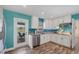Bright kitchen boasting stainless steel appliances and a teal accent wall at 2215 39Th W St, Bradenton, FL 34205