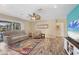 Spacious living room with a large TV, comfy seating, and wood floors at 2215 39Th W St, Bradenton, FL 34205