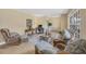 Living room with wicker furniture, wood flooring, and large windows at 2215 39Th W St, Bradenton, FL 34205