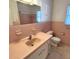 Pink-tiled bathroom with vanity, sink, toilet, and shower at 2253 Arlington St, Sarasota, FL 34239