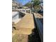 Wooden dock leading to a canal with waterside property nearby, excellent for boating enthusiasts at 2835 N Beach Rd, Englewood, FL 34223