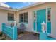 Mid-century home with teal door and patio at 2835 N Beach Rd, Englewood, FL 34223