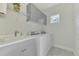 Practical laundry room equipped with a washer, dryer, sink, and cabinets at 3405 Box Turtle Ter, Parrish, FL 34219