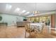 Dining room with wood-look floors, vaulted ceiling, and chandelier at 3424 Brookridge Ln, Parrish, FL 34219