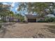 House exterior featuring a brick driveway and large trees at 3970 Prairie Dunes Dr, Sarasota, FL 34238