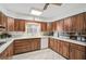 Galley style kitchen with wood cabinets and appliances at 3970 Prairie Dunes Dr, Sarasota, FL 34238