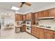 Kitchen with wood cabinets, appliances, and breakfast bar at 3970 Prairie Dunes Dr, Sarasota, FL 34238