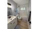 Updated bathroom with white vanity, subway tile, and a bathtub at 4007 Asbury Pl, Sarasota, FL 34233