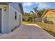 Fenced backyard view from the side of the house showcasing a concrete patio at 4064 Velarde Ln, Sarasota, FL 34235