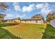 Spacious backyard with a white picket fence, perfect for outdoor activities at 4064 Velarde Ln, Sarasota, FL 34235