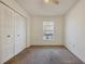 Bedroom with carpeted flooring, ceiling fan, large window, and double closet at 4064 Velarde Ln, Sarasota, FL 34235