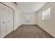 Unfurnished bedroom with carpeted flooring, closet, and large window at 4064 Velarde Ln, Sarasota, FL 34235
