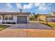 Long concrete driveway leading to attached one-car garage at 4064 Velarde Ln, Sarasota, FL 34235
