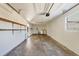 Spacious garage interior with storage shelves and laundry hookups at 4064 Velarde Ln, Sarasota, FL 34235