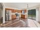 Bright kitchen with stainless steel appliances, wood cabinets, and sliding glass doors to the backyard at 4064 Velarde Ln, Sarasota, FL 34235