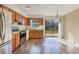Kitchen with stainless steel appliances, wood cabinets, and sliding glass doors leading to the backyard at 4064 Velarde Ln, Sarasota, FL 34235