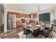 Kitchen with dining table, stainless steel appliances, wood cabinets, and sliding glass doors at 4064 Velarde Ln, Sarasota, FL 34235