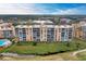 Condo building, pool, and landscaping overview at 4550 Pinebrook Cir # 304, Bradenton, FL 34209