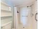 Bathroom with shower stall, grab bars, and a linen shelf at 4550 Pinebrook Cir # 304, Bradenton, FL 34209