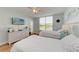 Bedroom with two twin beds, white dresser, and access to balcony at 4550 Pinebrook Cir # 304, Bradenton, FL 34209
