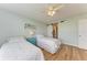 Guest bedroom with two twin beds, a ceiling fan, and a barn door at 4550 Pinebrook Cir # 304, Bradenton, FL 34209