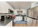 Modern kitchen with stainless steel appliances and granite countertops at 4550 Pinebrook Cir # 304, Bradenton, FL 34209