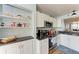 Modern kitchen with white cabinets, granite countertops, and stainless steel appliances at 4550 Pinebrook Cir # 304, Bradenton, FL 34209