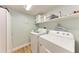 Laundry closet with washer and dryer, and additional shelving at 4550 Pinebrook Cir # 304, Bradenton, FL 34209