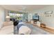 Bright living room with balcony access and view of the outdoors at 4550 Pinebrook Cir # 304, Bradenton, FL 34209